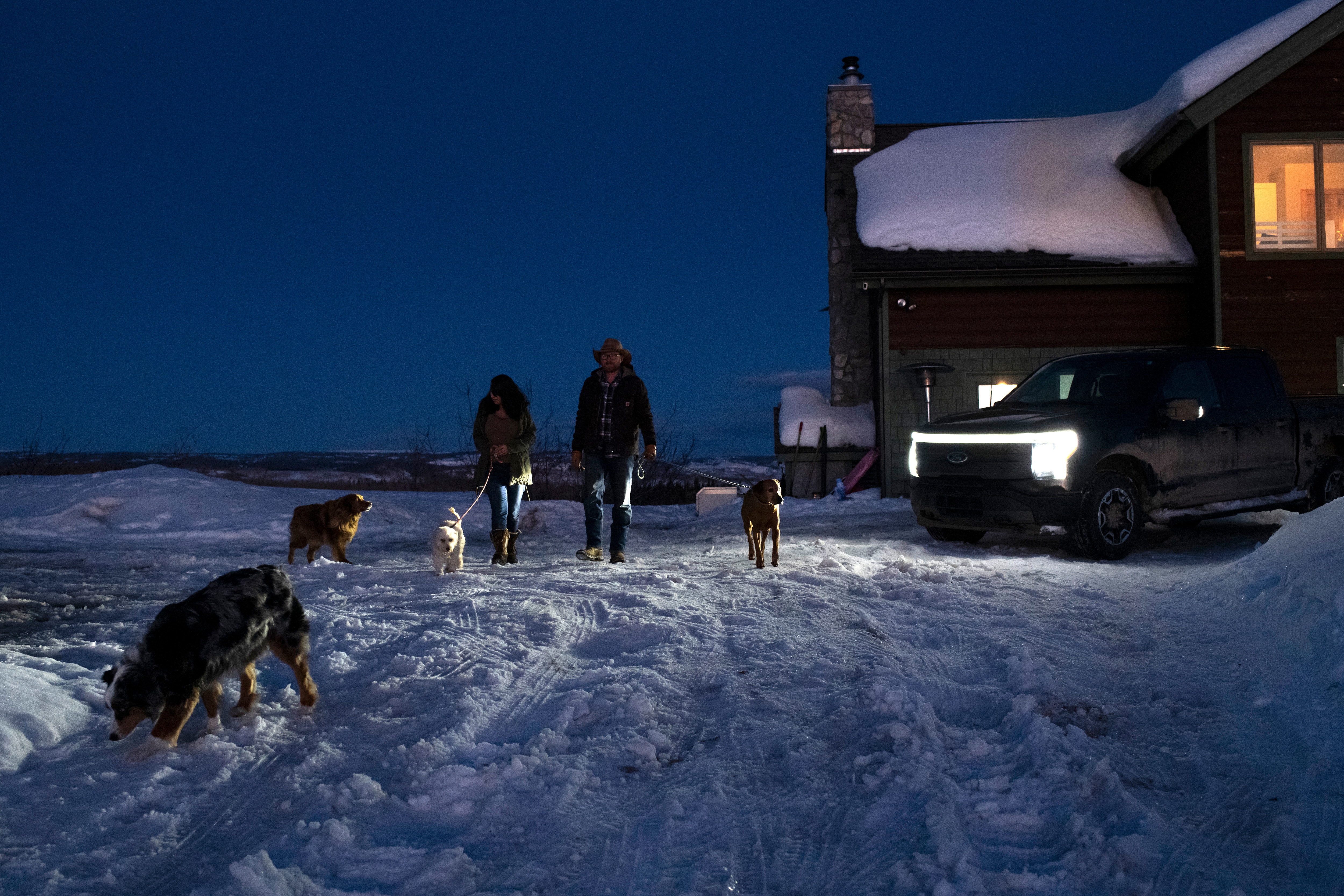 Amy Westby and Ben Westby walk the dogs they’re boarding with use of the zone lighting from their Ford F-150 Lightning on Sunday, March 17, 2024 at their home in New Castle, Colorado. Rachel Woolf for Ford